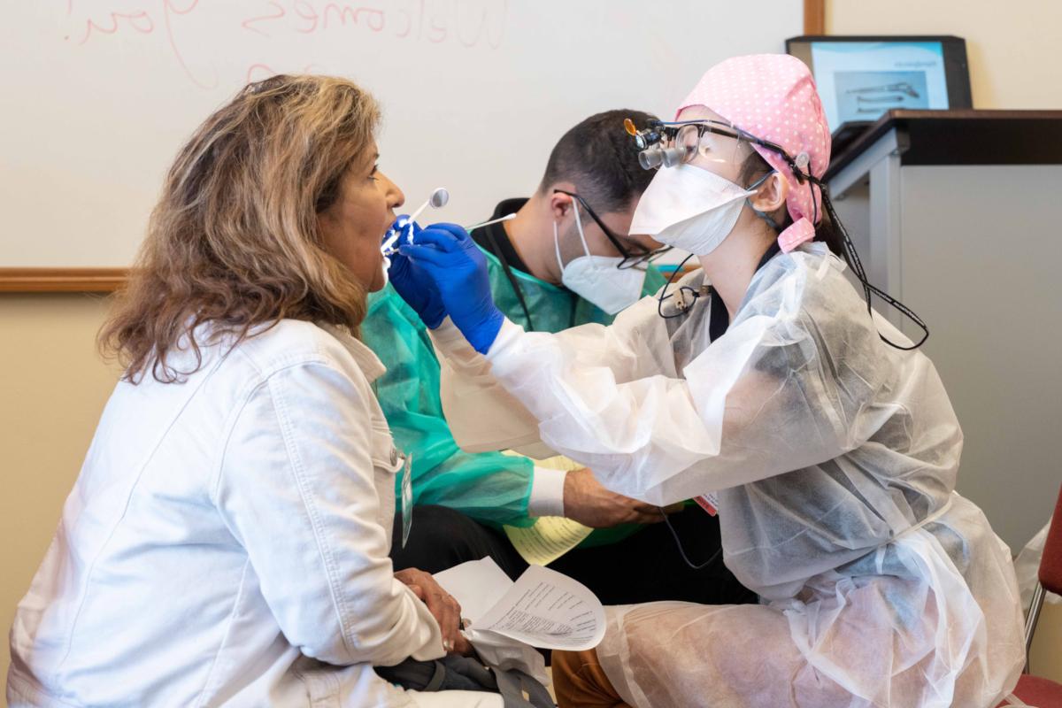 a dugoni dental student treats a patient